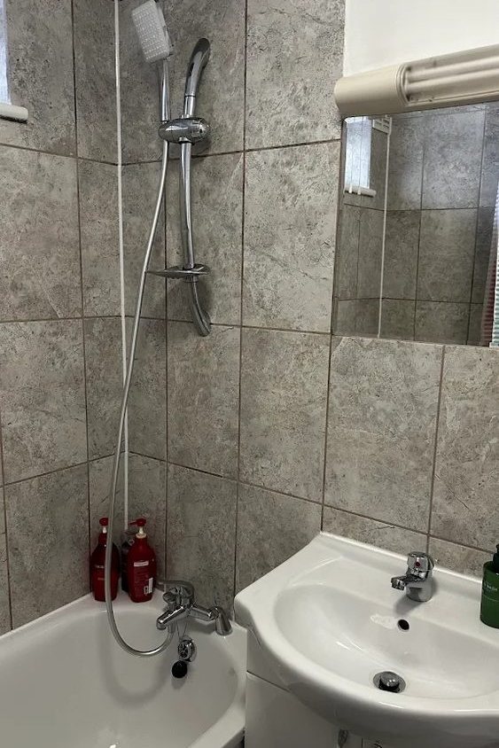 Airbnb turnover clean in Hampstead, London — bathroom with bath, shower, tiling and basin cleaned